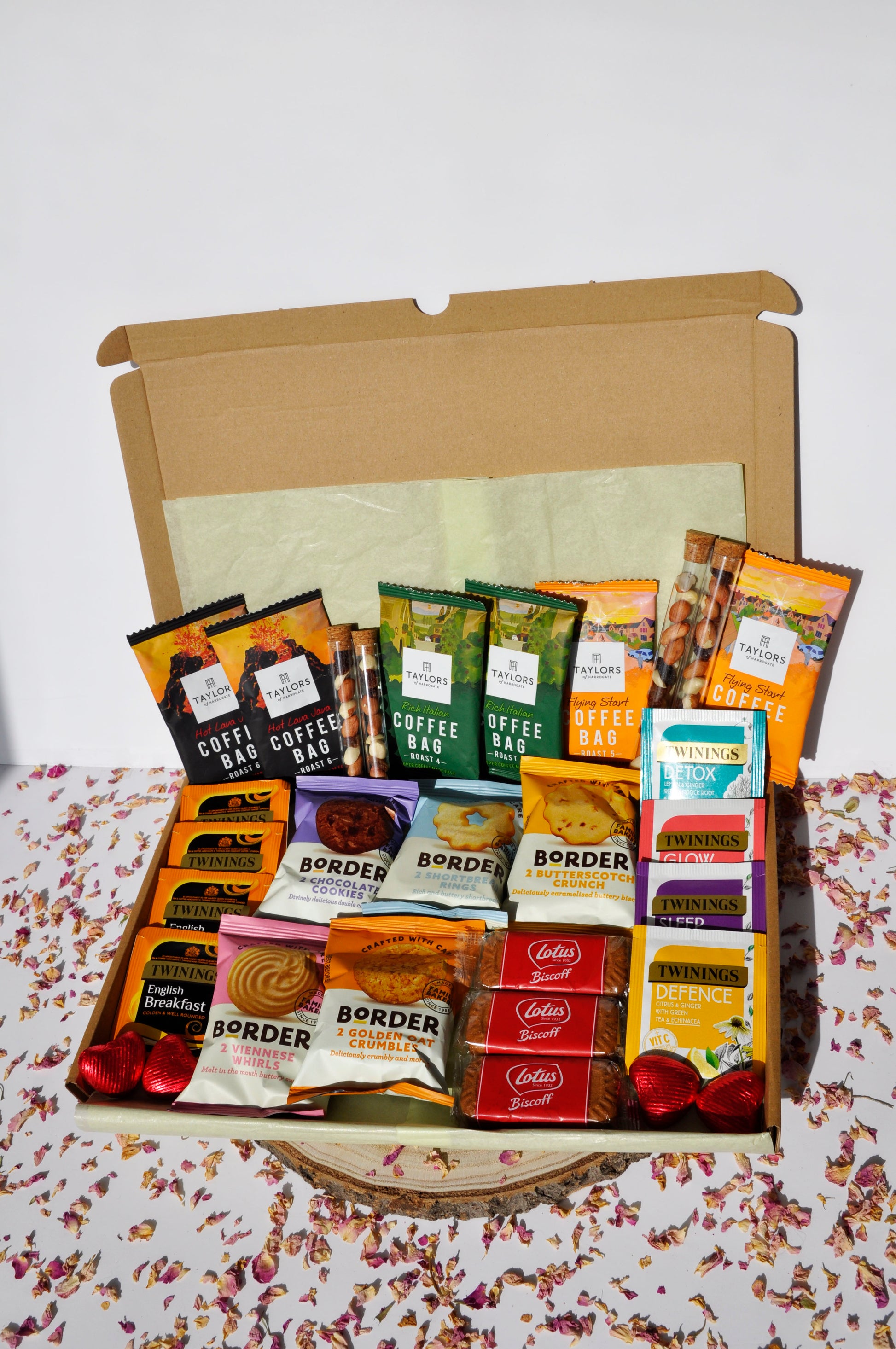 large letterbox box containing 6x Taylor's coffee boxes (2 of each types of roast) 4x Tubes of Fruit and Nut mix (2 small and 2 large) 5x Border Biscuits mini packs (will try to add one of each flavour, unless requested otherwise) 4x Twinings breakfast teas 4x Twinings herbal teas 3x Lotus Biscoff Biscuits 4x Heart Chocolates
