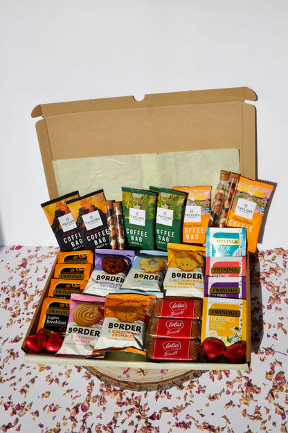 large letterbox box containing 6x Taylor's coffee boxes (2 of each types of roast) 4x Tubes of Fruit and Nut mix (2 small and 2 large) 5x Border Biscuits mini packs (will try to add one of each flavour, unless requested otherwise) 4x Twinings breakfast teas 4x Twinings herbal teas 3x Lotus Biscoff Biscuits 4x Heart Chocolates