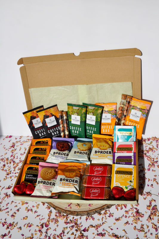 large letterbox box containing 6x Taylor's coffee boxes (2 of each types of roast) 4x Tubes of Fruit and Nut mix (2 small and 2 large) 5x Border Biscuits mini packs (will try to add one of each flavour, unless requested otherwise) 4x Twinings breakfast teas 4x Twinings herbal teas 3x Lotus Biscoff Biscuits 4x Heart Chocolates