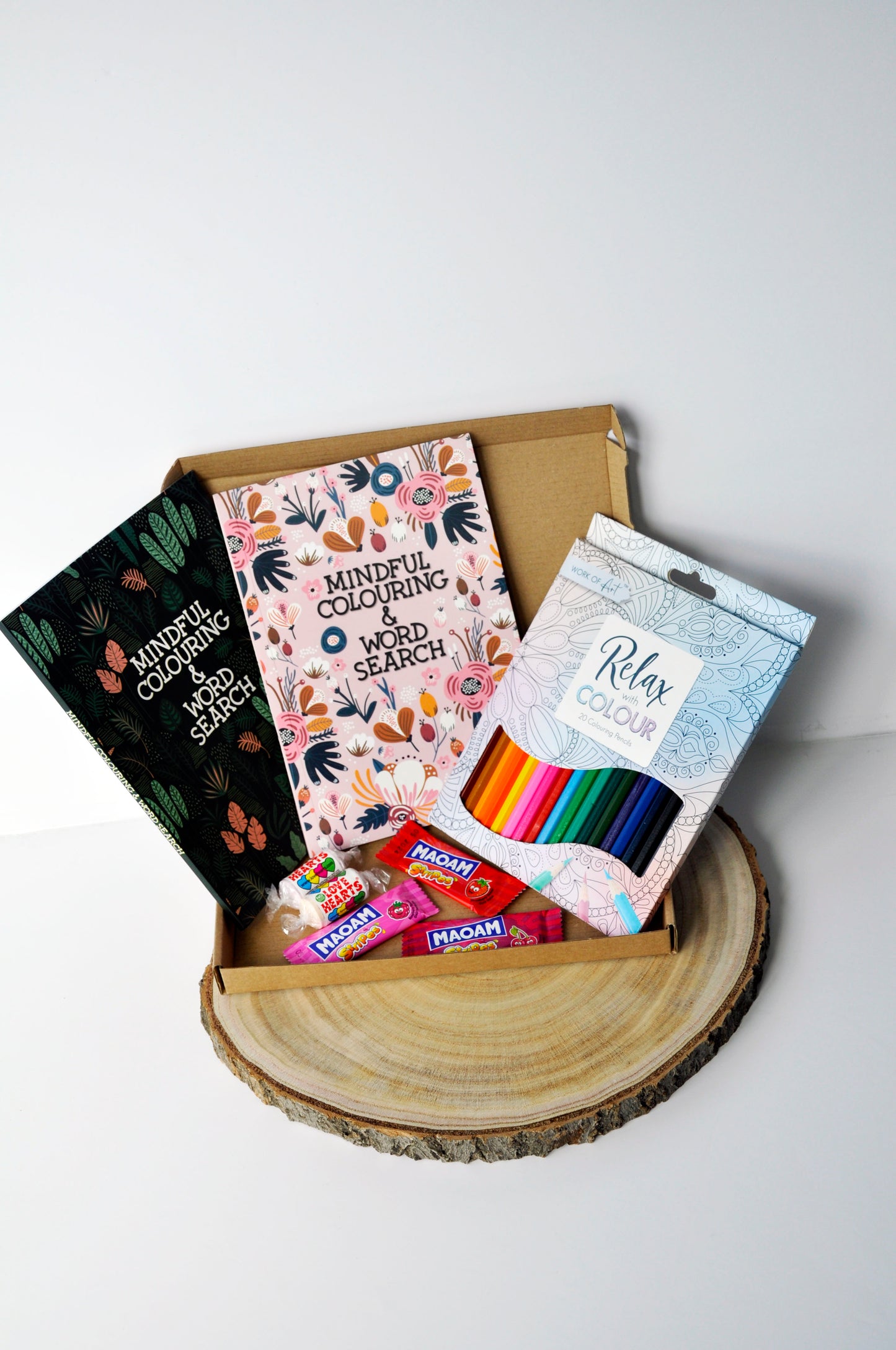 medium letterbox box with 2 mindful colouring and word search books, a set of 20 pencils, 3 maoam sweets, 2 love heart sweets